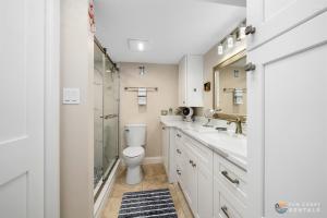 a bathroom with a toilet sink and a shower at Spectacular Ocean View STEPS from the Beach and Pool! Third Floor Studio! in Edgewater +17 photos