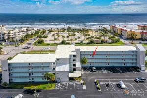 an aerial view of a building near the ocean at Spectacular Ocean View STEPS from the Beach and Pool! Third Floor Studio! in Edgewater