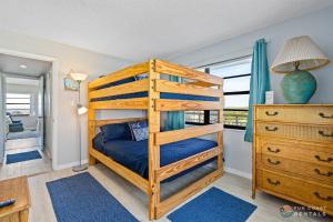 a bedroom with a bunk bed and a dresser at Beachfront 4th Floor Condo with Spectacular Beach & Ocean Views and Pool! in Bottle Island +28 photos