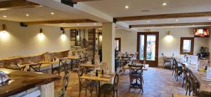 a restaurant with tables and chairs and a bar at U PASTURELLU in Pioggiola