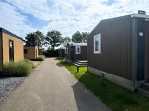 a road leading up to a row of mobile homes at Chalet Aqua in Netherlands with Veranda in Koudekerke