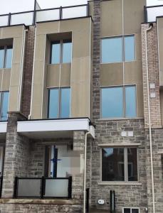 a building with a blue cross on the side of it at XTO Hotel in Markham +3 photos