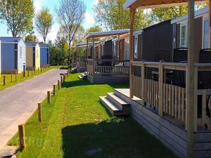 a row of mobile homes in a park at Chalet Aqua in Netherlands with Veranda in Koudekerke