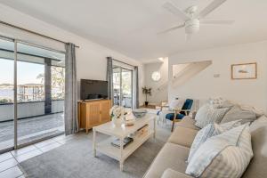 a living room with a couch and a tv at Lakefront Retreat with Kayaks and Fire Pit in Clermont in Clermont