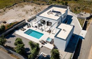 an aerial view of a house with a swimming pool at Villa Thora in Podorljak