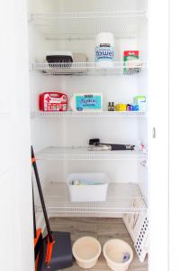 a refrigerator with white shelves and a mop at Luxury 5-Star Retreat - Family & Pet Friendly in Southaven