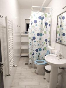 a bathroom with a toilet and a shower curtain at High Hostel in Budva
