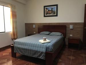 a bedroom with a bed with a tray on it at Hospedaje Maju Del Oriente in Pucallpa