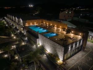 an overhead view of a building with a swimming pool at night at Azores Homes Resort & Spa in Ponta Delgada
