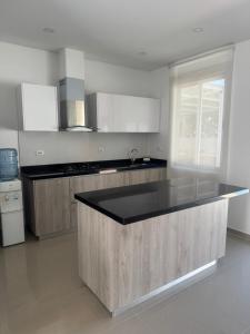 a kitchen with a large island in the middle at Beautiful house,Carmen de Apicalá in San Antonio