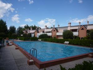 a large swimming pool in front of a building at Residence Nuovo Sile in Cavallino-Treporti