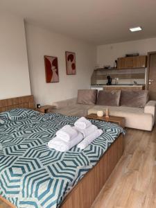 a bedroom with a large bed with towels on it at LINA Studios - City Center in Ohrid