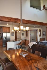 a kitchen and living room with a wooden dining table at Luxury condo with stunning views! in Fraser