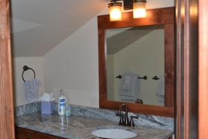a bathroom with a sink and a mirror at Luxury condo with stunning views! in Fraser +22 photos
