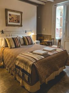 a large bed with blankets and pillows in a bedroom at Posada Niña Juana in Villa Dolores +66 photos