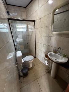 a bathroom with a toilet and a sink and a shower at Guarda do Embau Gran Kahuna in Palhoça