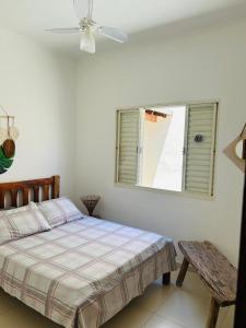 a white bedroom with a bed and a window at Pouso Canastra in São João Batista do Glória +34 photos