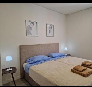 a bedroom with a bed and two pictures on the wall at Casa do Leão in Évora