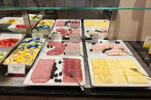 a display case filled with lots of different types of food at Garner Hotel Oberhausen by IHG in Oberhausen +148 photos