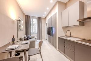 a kitchen and living room with a table and chairs at The Bliss Apartments in Genova