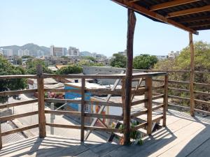 a balcony with a wooden railing and a view of a city at mirador 1 in Santa Marta