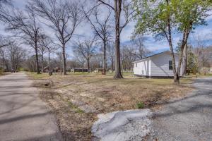 a house on the side of a road with trees at Half-Mi to Dtwn New Cottage in Jefferson! in Jefferson