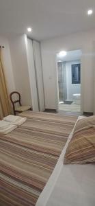 a hotel room with two beds and a bathroom at Casa Do Olival - Suítes in São João da Pesqueira