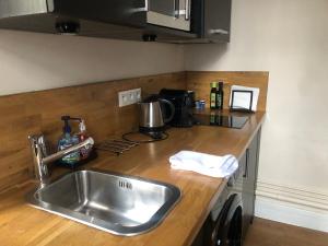 a kitchen with a sink and a counter top at Jardin Abbatiale in Rouen