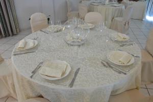 
a white table topped with white plates filled with food at Hotel Bed&Breakfast Tiffany in Campobello di Licata
