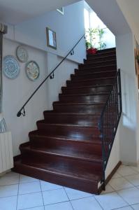 a staircase in a house with brown steps at Hotel Bed&Breakfast Tiffany in Campobello di Licata