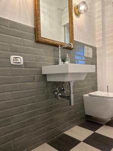 a bathroom with a sink and a toilet at Charming Beachfront Retreat in Riposto +28 photos