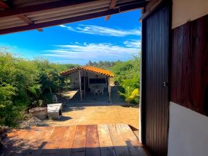 a view of a patio from the door of a house at Shanti Lanka Ashram in Guayabas