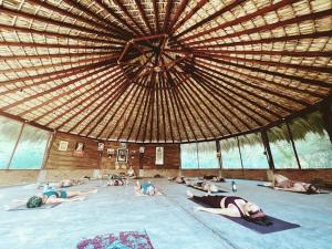 a group of people laying on the floor in a large building at Shanti Lanka Ashram in Guayabas