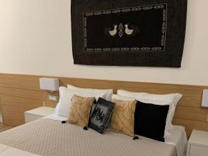 a bedroom with a bed with pillows on it at Domo Grace in Porto San Paolo