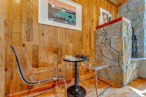 a room with a stone wall with two chairs and a table at Cozy Carnelian Bay Escape with Deck and Foosball in Carnelian Bay