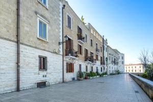 an empty street next to a brick building at Seaside Apartment Near St Nicholas Basilica in Bari