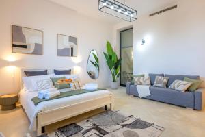 a living room with a bed and a couch at Seaside Apartment Near St Nicholas Basilica in Bari