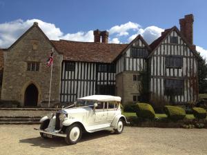 an old white car parked in front of a building at Long Crendon Manor B&B in Long Crendon