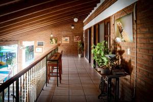 a balcony with a table and chairs on a brick wall at HOTEL BOUTIQUE EL RANCHO OLIVO in Villamontes