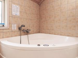 a bath tub with a faucet in a bathroom at 6 person holiday home in Højby-By Traum in Højby +29 photos