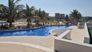a view of a swimming pool at a resort at Hawana Salalah Poolside Apartment in Salalah
