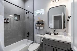 a bathroom with a sink and a toilet and a mirror at 10 Mins from NRG 3BR 3BA in Houston +28 photos