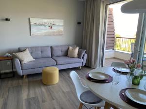 a living room with a couch and a table at Vila Primorka-Apartmani Lavanda in Šilo