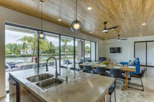 an open kitchen and dining room with a view of the water at Beyond the Blue at Naia Resort in Seine Bight Village