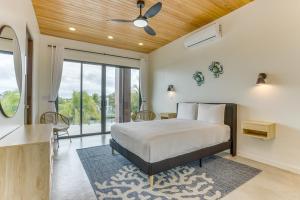 a bedroom with a bed and a ceiling fan at Beyond the Blue at Naia Resort in Seine Bight Village +52 photos