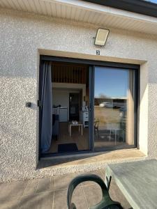 a sliding glass door to a patio with a table at Studio Cosy - Proche MEETT 300m in Cornebarrieu