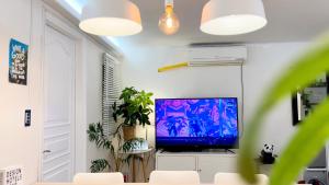 a living room with a flat screen tv on a wall at Pachira House in Seoul