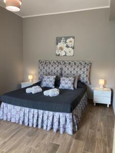 a bedroom with a large bed with two pillows at Costa degli Dei in Briatico
