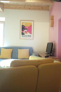 a bedroom with a bed and a tv on a table at Maison Saint-Martin in Calvignac