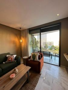 a living room with a couch and a table at Luxury 1-Bedroom Apartment in Casablanca